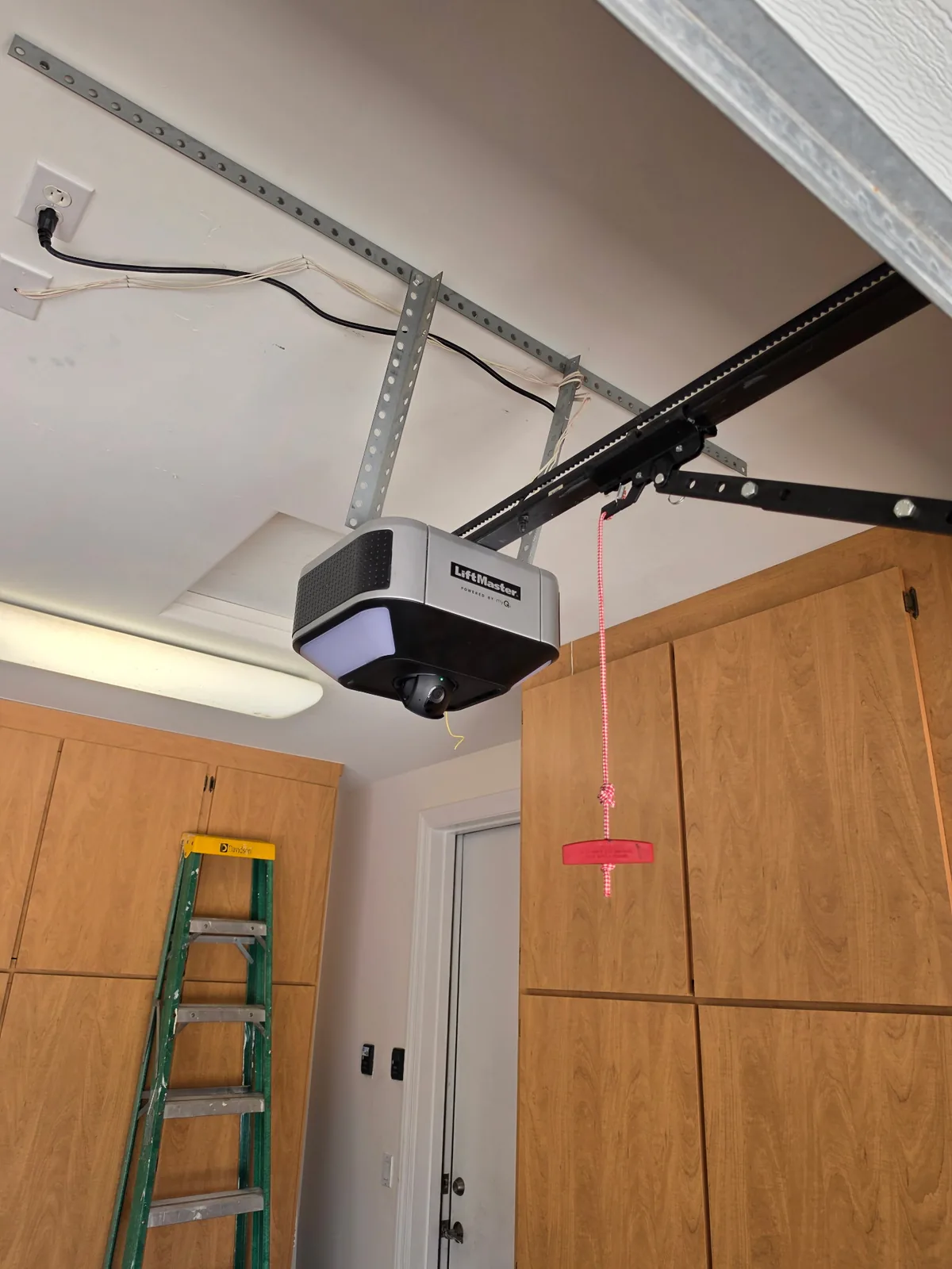 LiftMaster garage door opener installed by Align, seen wide, with the rail running back to the header bracket above the door